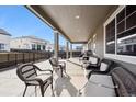 Relaxing covered patio with ample seating, perfect for outdoor entertaining and dining at 226 S Shady Grove Ct, Aurora, CO 80018