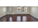 Bright living room with hardwood floors and two windows at 12906 W 24Th Pl, Golden, CO 80401
