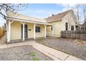 Charming home featuring a covered front porch, tidy gravel, and walkway at 4764 High St, Denver, CO 80216