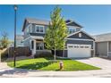 Two-story home featuring a manicured front yard, two car garage, and inviting front porch at 7958 Tejon St, Denver, CO 80221