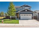 Two-story home with a manicured lawn, two-car garage, and inviting front porch, plus mature shade tree at 7958 Tejon St, Denver, CO 80221