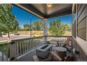 Inviting front porch featuring a concrete fire pit and Adirondack chairs offers a cozy outdoor living space at 7958 Tejon St, Denver, CO 80221