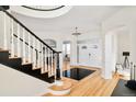 Elegant foyer with hardwood floors, staircase and chandelier at 27 Tamarade Dr, Littleton, CO 80127