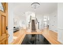 Grand foyer with hardwood floors, elegant staircase, chandelier and open layout at 27 Tamarade Dr, Littleton, CO 80127
