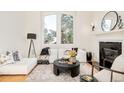 Cozy living room with large windows, fireplace and stylish decor at 27 Tamarade Dr, Littleton, CO 80127