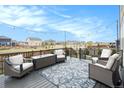 Cozy outdoor deck featuring stylish patio furniture and string lights, perfect for relaxing at 8395 E 132Nd Pl, Thornton, CO 80602