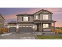 Beautiful two-story home showcasing stone accents, a three-car garage, and manicured landscaping at 8395 E 132Nd Pl, Thornton, CO 80602