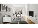Bright living room with a cozy fireplace and an open floor plan at 33 S Ogden St, Denver, CO 80209