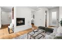 Open living room with hardwood floors, a fireplace, and modern decor at 33 S Ogden St, Denver, CO 80209