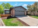 Exterior view of brick home with well-kept lawn, garage, and newer siding at 2184 S Braun Way, Lakewood, CO 80228