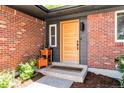 Stylish front door with brick accents and modern planter boxes at the entry at 2184 S Braun Way, Lakewood, CO 80228