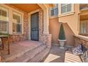 Close-up of the front porch entrance with brick accents and comfortable seating at 9351 Viaggio Way, Highlands Ranch, CO 80126