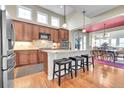 Modern kitchen with stainless steel appliances, granite countertops, and breakfast bar seating at 9351 Viaggio Way, Highlands Ranch, CO 80126