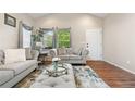 Comfortable living room with neutral tones, plush seating, and bright windows with nice trim at 9631 S Dover Way, Littleton, CO 80127