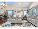 Elegant living room featuring high ceilings, ample natural light, and stylish furnishings at 9631 S Dover Way, Littleton, CO 80127