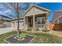 Beautiful home with stone accents, a three-car garage, and a cozy front porch at 14969 Elsinore Ave, Parker, CO 80134