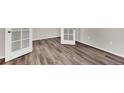 Bright bedroom featuring stylish wood-look flooring and modern white doors at 3325 Umber Cir, Castle Rock, CO 80109