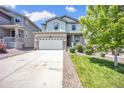 Beautiful two-story home with a spacious driveway, lovely landscaping, and inviting curb appeal at 3325 Umber Cir, Castle Rock, CO 80109