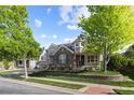 Charming front exterior showcasing brick accents, lush landscaping, and a welcoming front porch at 6040 Virgil St, Arvada, CO 80403