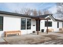 White house with black accents and wood planters at 3407 W Arkansas Ave, Denver, CO 80219