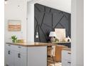 Modern kitchen with white shaker cabinets, butcher block island, and geometric backsplash at 3407 W Arkansas Ave, Denver, CO 80219