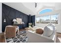 Bright living room features a wood-burning stove, vaulted ceiling, and large windows at 3407 W Arkansas Ave, Denver, CO 80219