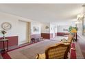 Inviting lobby area with comfortable seating, a decorative wall clock, and a view of an elevator at 13952 E Marina Dr # 509, Aurora, CO 80014