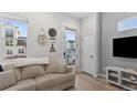 Bright entryway with coat closet and view into living room at 3553 W 63Rd Ave, Denver, CO 80221