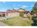 Well-maintained single-story home with a manicured lawn and mature trees at 5106 Eagle Ct, Denver, CO 80239