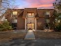 Brick apartment building featuring a unique roof line, manicured landscaping, and inviting entrance at 7755 E Quincy Ave # 203A2, Denver, CO 80237
