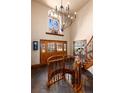 Grand foyer showcasing a winding staircase, tiled floors, and wood-framed glass doors leading to the outdoors at 730 Crescent Ln, Lakewood, CO 80214