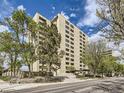 Multi-story condominium building with brick and a manicured landscape, set back from the street at 800 Pearl St # 204, Denver, CO 80203