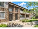 Attractive townhome exterior showcasing stone accents, private balconies, and manicured landscaping at 9397 Las Ramblas Ct # D, Parker, CO 80134