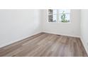 Bright bedroom featuring light wood floors and a large window at 45910 Gentry Ave, Bennett, CO 80102