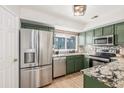 Modern kitchen with stainless steel appliances and granite countertops at 12035 Leyden St, Brighton, CO 80602