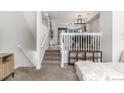 Elegant staircase leading to the upper level of the home at 12035 Leyden St, Brighton, CO 80602