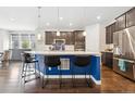 Modern kitchen with a large island and blue details at 9572 Taylor River Cir, Littleton, CO 80125