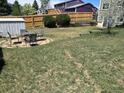 A spacious backyard featuring a patio set and privacy fencing at 3961 S Uravan St, Aurora, CO 80013