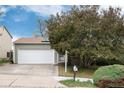 Attractive home showcasing a two-car garage, and well-manicured greenery at 3961 S Uravan St, Aurora, CO 80013