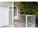 Inviting home entrance featuring a charming porch and freshly painted railing at 3961 S Uravan St, Aurora, CO 80013