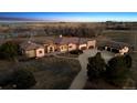 Aerial view of an estate home with mature trees, extended driveway, and lush landscaping at 2102 Shoreside Dr, Berthoud, CO 80513