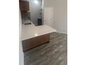 Modern kitchen with island, pendant lighting, and stainless steel appliances at 4876 E Kentucky Ave # F, Denver, CO 80246