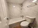 Clean bathroom with tiled walls, a bathtub, and modern fixtures at 1020 15Th St # 25D, Denver, CO 80202