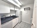 Efficient kitchen with white cabinets, appliances and dark countertops at 1020 15Th St # 25D, Denver, CO 80202