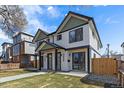 Beautiful modern duplex with white siding, black trim, green accents, and a walkway leading to the entrance at 2432 Ames St, Edgewater, CO 80214