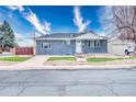 Classic blue brick house with manicured front yard, concrete driveway, and separate garage at 11367 Fowler, Northglenn, CO 80233