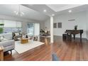 Cozy living room featuring hardwood floors, comfortable seating, and a sliding glass door to the outdoors at 10226 E Fair Pl, Englewood, CO 80111