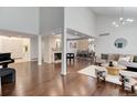 Open-concept space featuring hardwood floors, fireplace, piano, and seamless transition to the dining area at 10226 E Fair Pl, Englewood, CO 80111