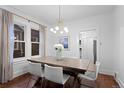 Contemporary dining room featuring a modern light fixture, hardwood floors, and ample natural light at 1245 Garfield St, Denver, CO 80206