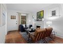 Bright living room with a fireplace, hardwood floors, and comfortable seating, illuminated by natural light at 1245 Garfield St, Denver, CO 80206